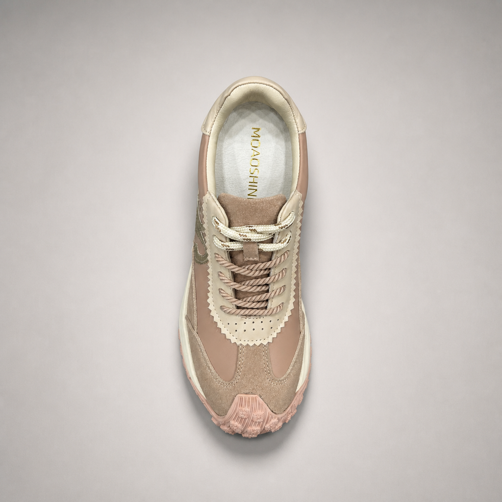 Pink sneaker top view showing a panelled lace-up upper