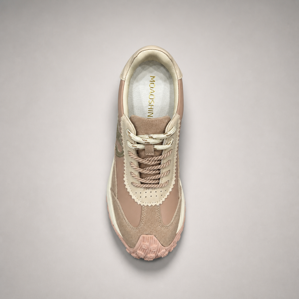 Pink sneaker top view showing a panelled lace-up upper