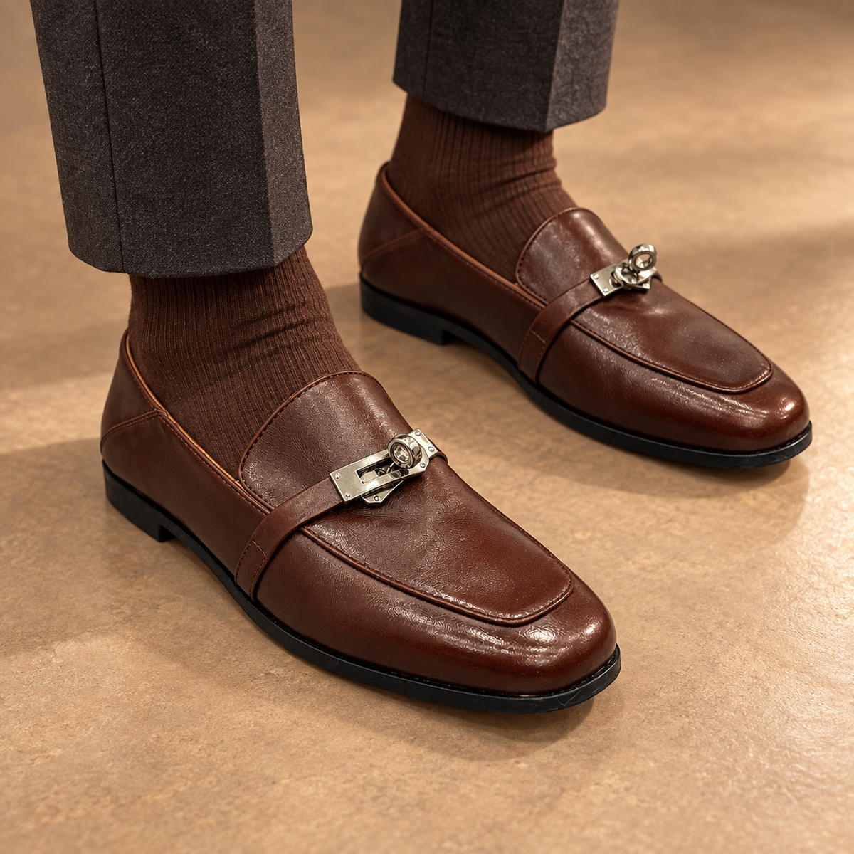 Ivory washed horse leather metal-accent mule loafers worn with beige trousers and ivory socks