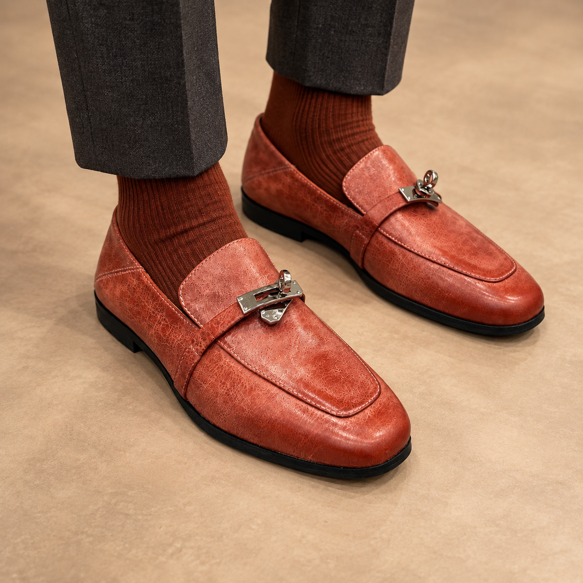 Rust washed horse leather metal-accent loafers worn with charcoal trousers and rust socks
