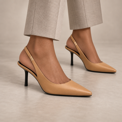 Tan pointed-toe leather slingback pumps worn with stone trousers