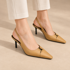 Tan square-toe metal-accent slingback pumps worn with ivory trousers