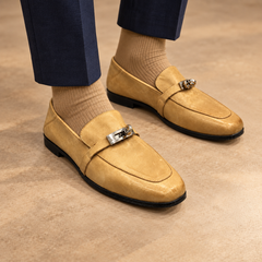 Tan washed horse leather metal-accent loafers worn with navy trousers and tan socks