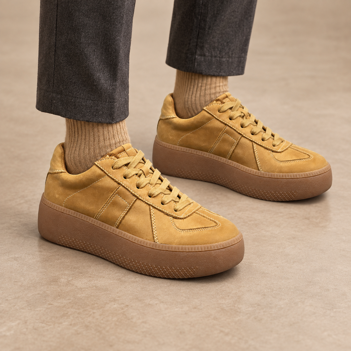 Tan washed horse leather platform sneakers worn with charcoal trousers and tan socks