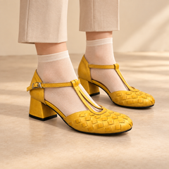 Yellow water-washed horse leather T-strap block-heel pumps worn with beige trousers