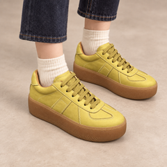 Yellow washed horse leather platform sneakers worn with dark denim and cream socks